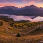 Sunset over a vast national recreation area with mountains, lake, and hikers.